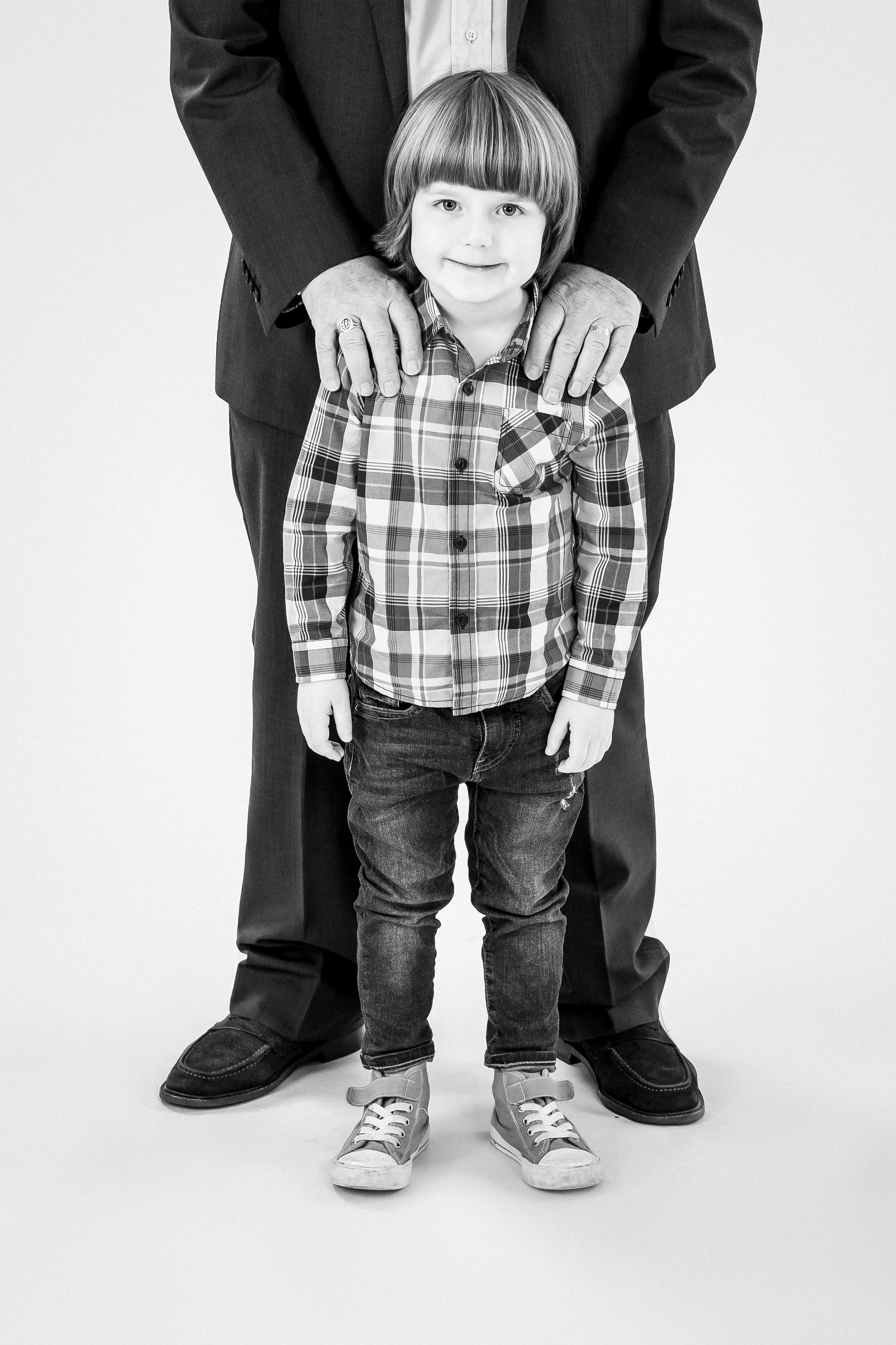 Black and white portrait of boy with father