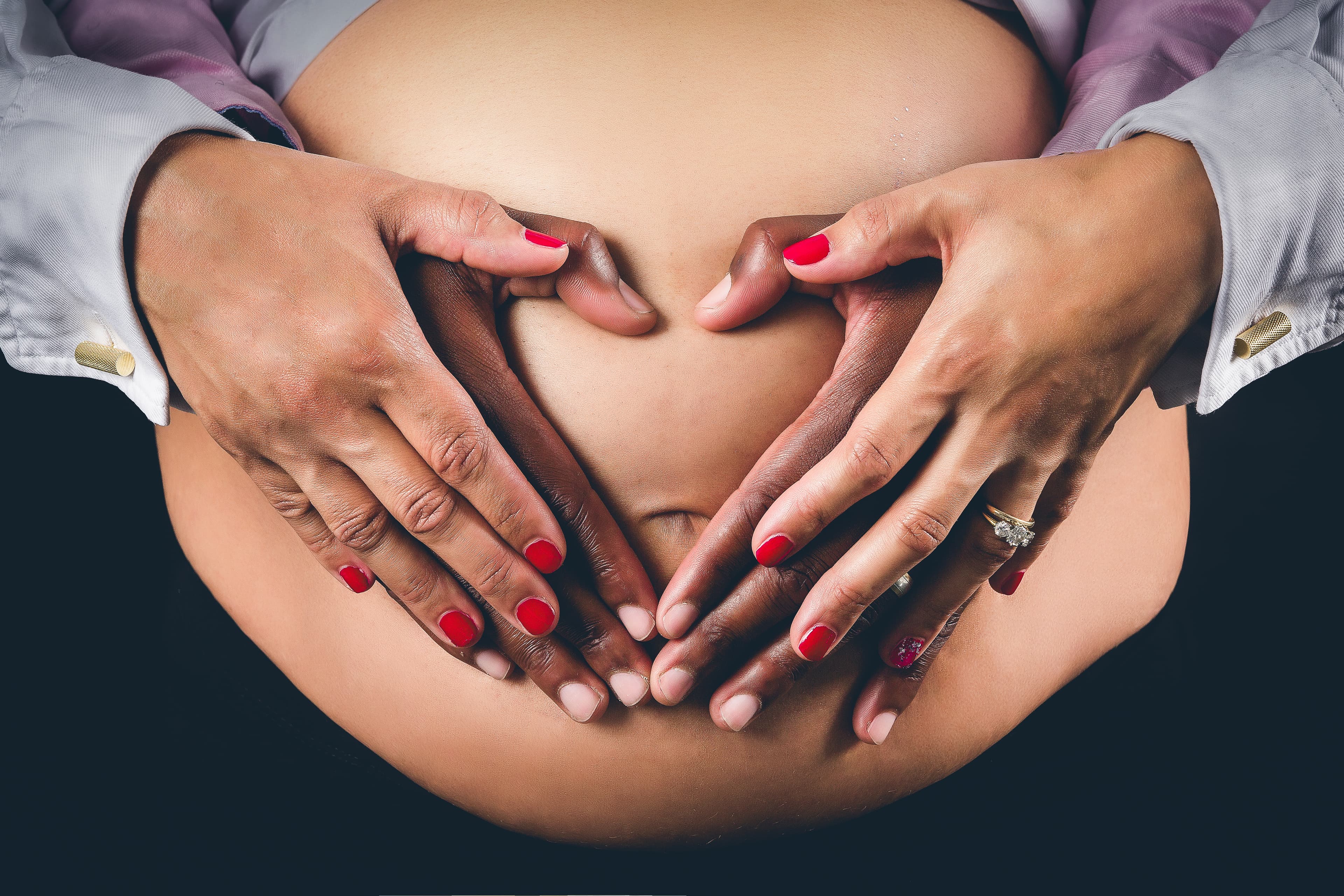 Couple hands heart on baby bump maternity portrait Edinburgh